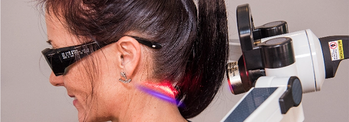 A woman is undergoing regenerative therapy on her head with laser treatment.